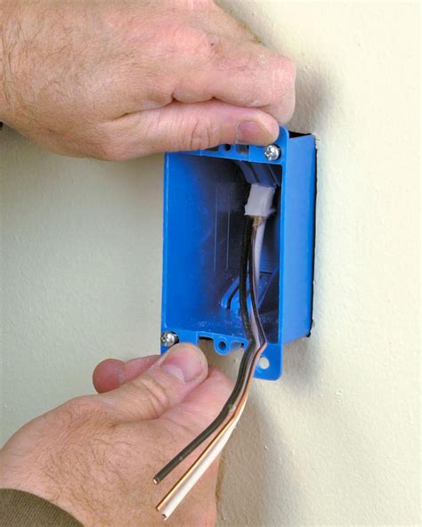 attaching electrical outlet box for light into wall|installing electrical box in finished wall.